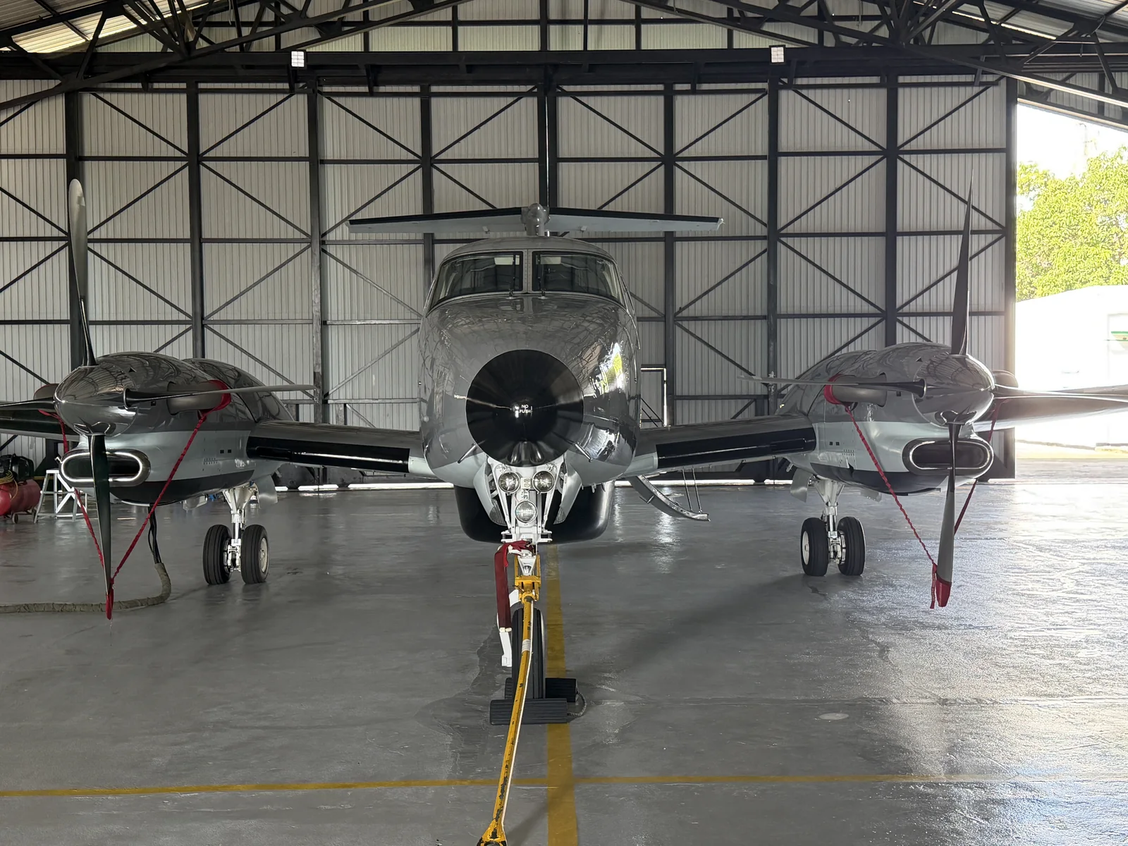 Front view of a King Air aircraft in a maintenance hangar